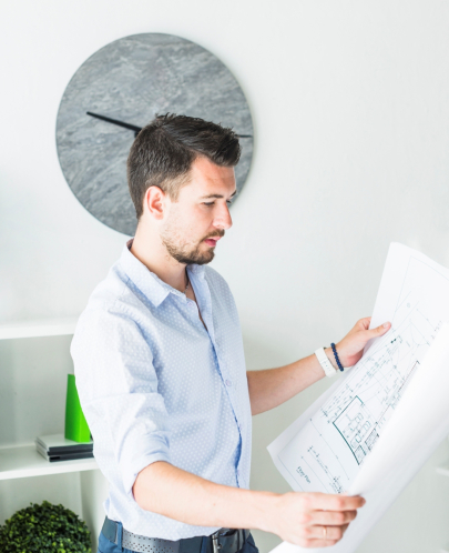 side-view-young-male-architect-looking-blueprint